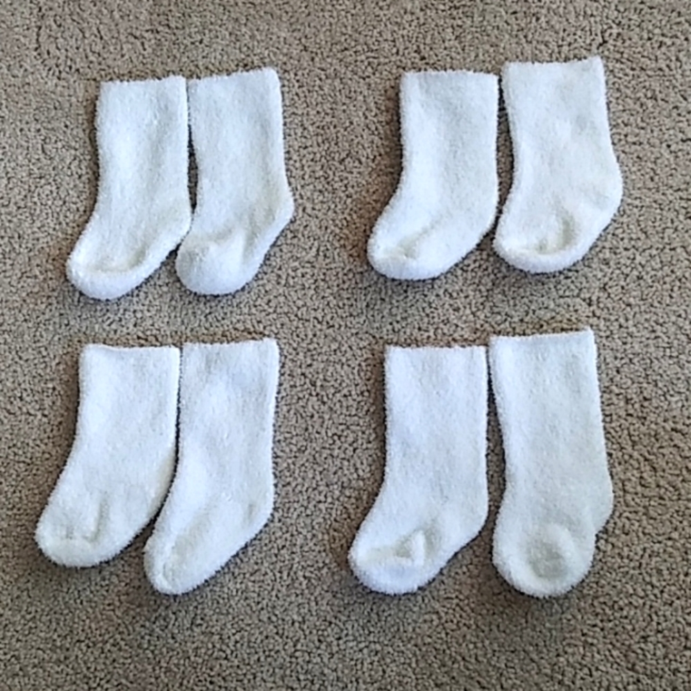4 pairs baby fuzzy socks. Ages newborn to 3 months.